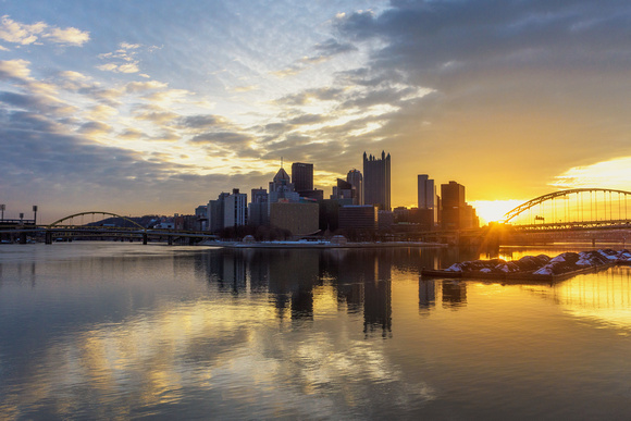 Pittsburgh reflects in the still waters of the Ohio River during a beautiful sunrise