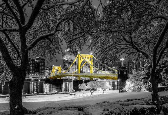 Trees frame the snow covered Clemente Bridge before dawn - Selective Color