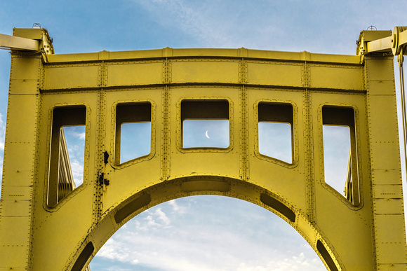 The Clemente Bridge frames the crescent moon over Pittsburgh