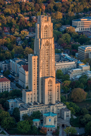 The sun illuminates the east side of the Cathedral of Learning in this aerial view