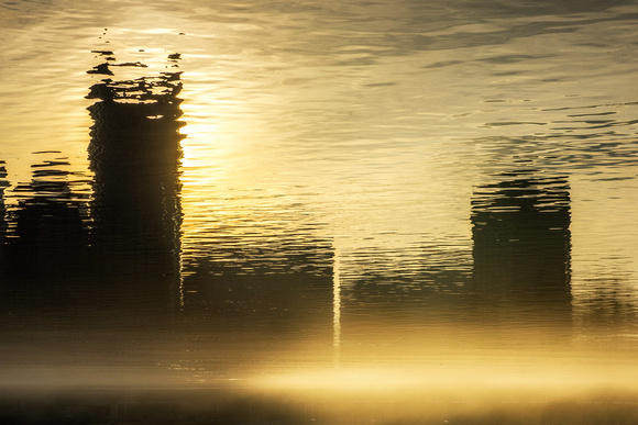 An abstract view of Pittsburgh reflecting in the rivers on a fogy morning