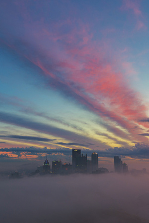 Beautiful colors fill the sky over Pittsburgh on a foggy morning
