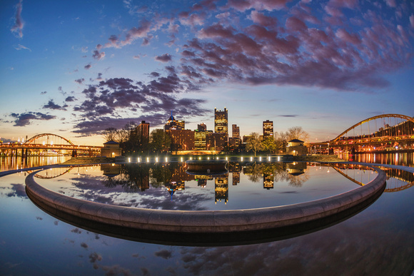 A beautiful sunrise reflects in the fountain at Point State Park in Pittsburgh