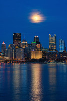The moon shines bright over Pittsburgh from the West End