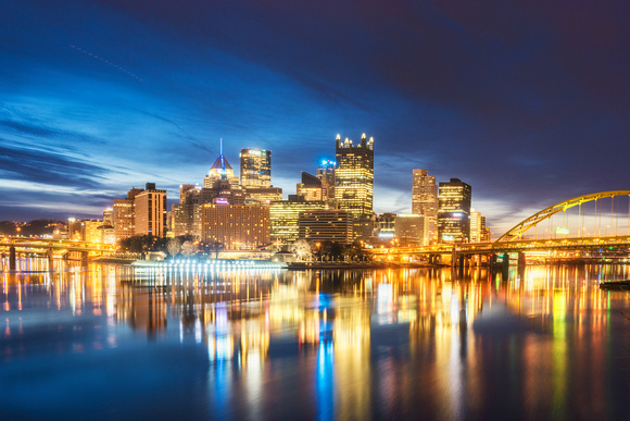 A glowing Pittsburgh skyline before dawn