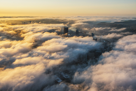Rivers of fog fill the sky over Pittsburgh