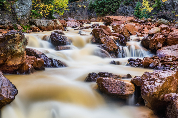 Water rushes over rocks in Red Creek in Colorado