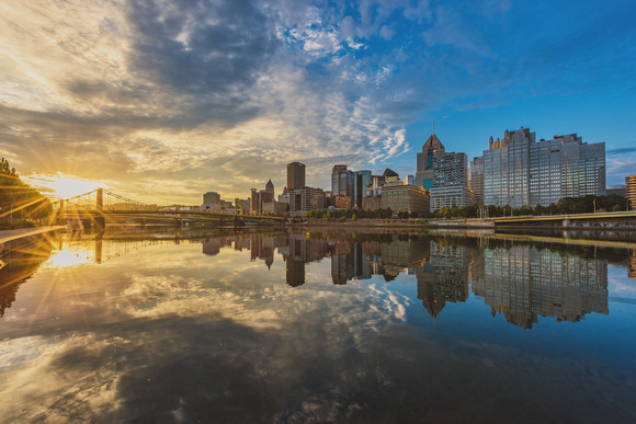 A beautiful sunrise reflects in the Allegheny River in PIttsburgh