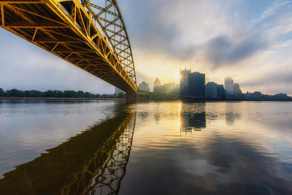 The Ft. Pitt Bridge reflects in the rivers on a foggy morning in Pittsburgh