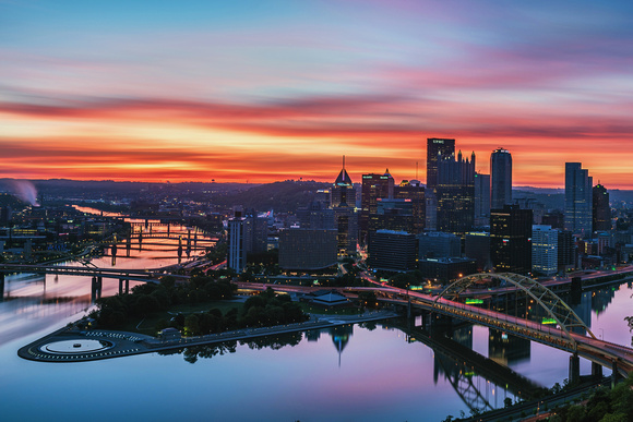 A colorful sunrise backdrops Pittsburgh