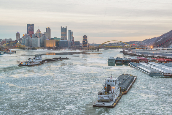 Two barges on Ohio River Pittsburgh ice West End Bridge