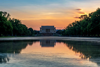 A long exposure of a deep orange sunset over the Lincoln Memorial in Washington DC