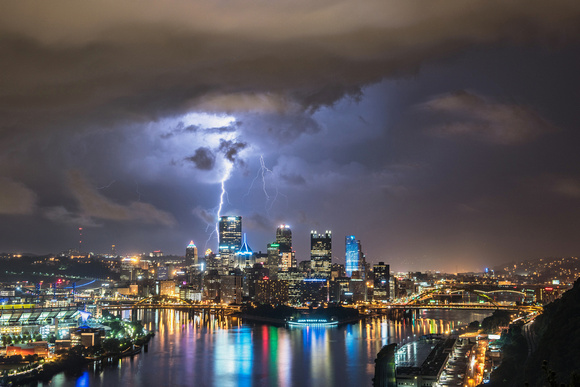 A lightning bolt strikes behind Pittsburgh during a summer storm
