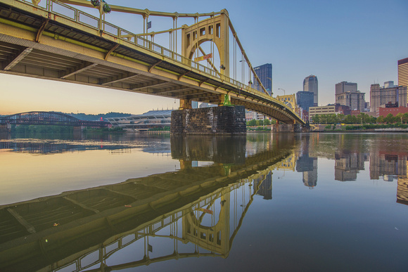 The Andy Warhol Bridge reflects in the Allegheny River in Pittsburgh