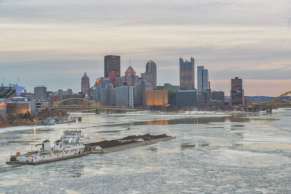 Barge in front of Pittsburgh on the iced over Ohio River from the West End Bridge