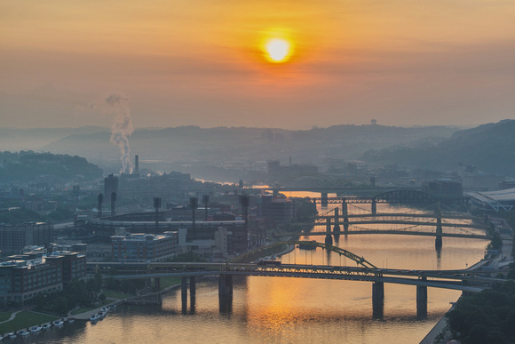 The sun lights up the Allegheny River at dawn in Pittsburgh