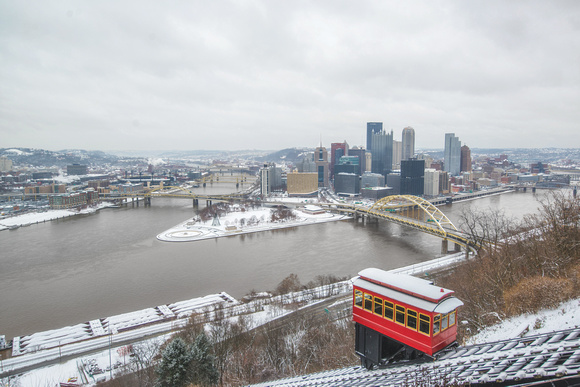 A snow covered incline rises up Mt. Washington on a cloudy day in Pittsburgh
