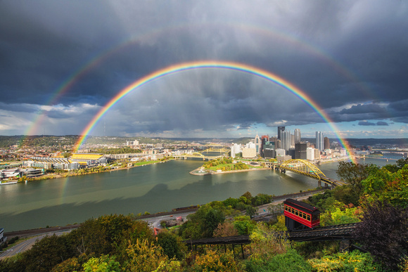 A double rainbow frames Pittsburgh during a fall storm