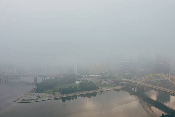 Only Point State Park is visible in Pittsburgh through the fog