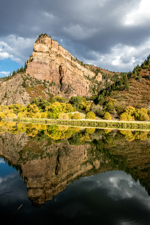 Glenwood Canyon reflects in still waters in Colorado