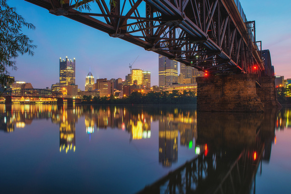 A view of Pittsburgh under the Panhandle Bridge before dawn in Pittsburgh