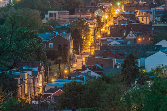 A lit up street on Troy Hill before dawn