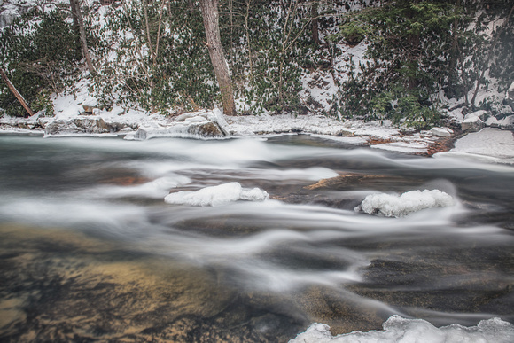 Rapids rush by at Flatrock at Ohiopyle State Park in the snow and ice