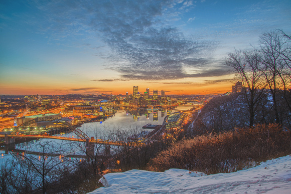 Fire red sky and snow over the Pittsburgh skyline in winter