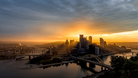 Sunlight pours through the city during a beautiful sunrise in Pittsburgh