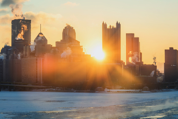 Sunrise through downtown Pittsburgh over the icy Ohio River