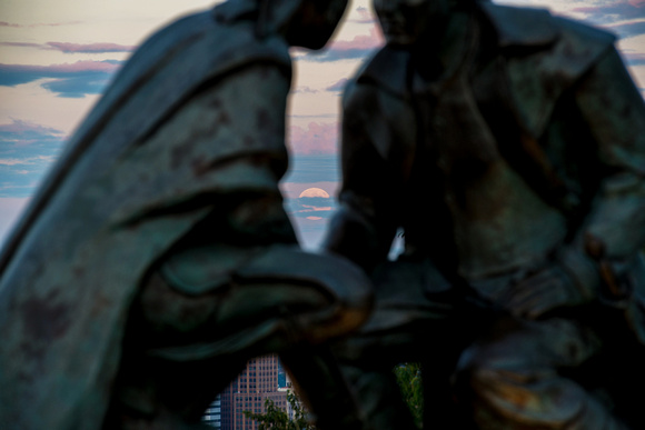The supermoon between the Point of View statue on Mt. Washington in Pittsburgh