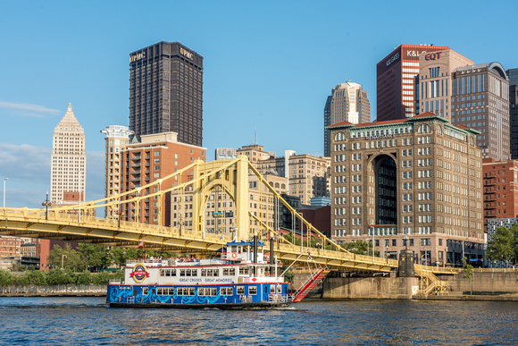 A Gateway Clipper boat sails under the Clemente Bridge in Pittsburgh