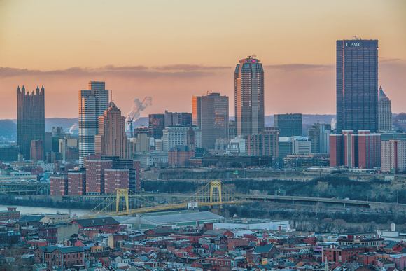 The Pittsburgh skyline shines at dusk from the South Side Slopes