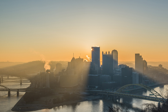 Sunflare by corner of Steel Building in downtown Pittsburgh at dawn