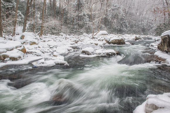 Snow falling around the upper section of the natural rock slides at Ohiopyle State Park