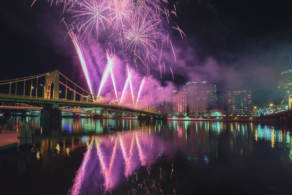 Fireworks reflect in the Allegheny River in Pittsburgh during Light Up Night 2014