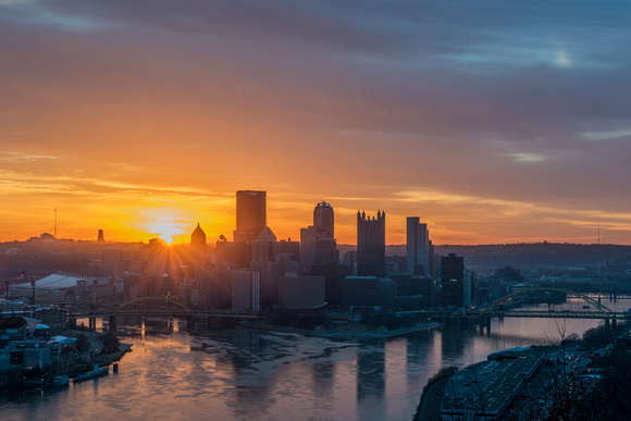 The sun rises over downtown Pittsburgh from the West End Overlook