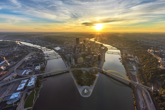 The sun shines over Pittsburgh from the air