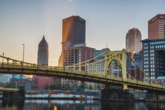 Sun peeking out from behind the Pittsburgh skyline in the morning HDR