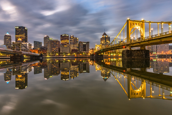 The Clemente Bridge reflects in the still waters of the Allegheny River