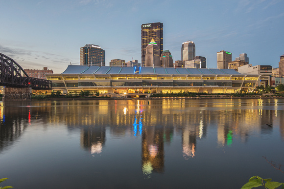 The Pittsburgh skyline and convention center reflect in the Allehgheny River