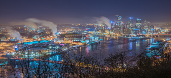 Pittsburgh glows over the icy rivers in winter