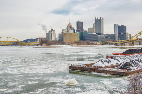An icy Ohio River and snow covered barge from the South Shore of Pittsburgh