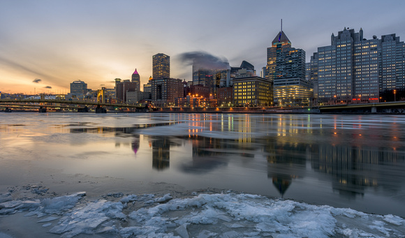 Reflections of Pittsburgh in the icy Allegheny