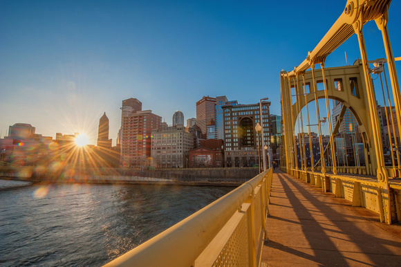 The sun rises through the Roberto Clemente Bridge in Pittsburgh