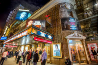People standing out front of the Broadhurst Theatre at night