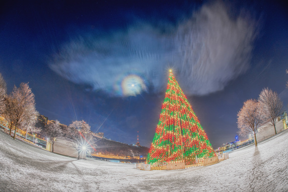 The moon and Christmas tree at Point State Park in the snow in Pittsburgh