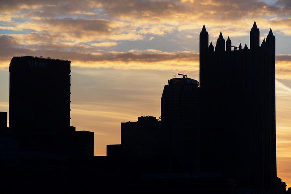 The Pittsburgh skyline silhouettes against the morning sky