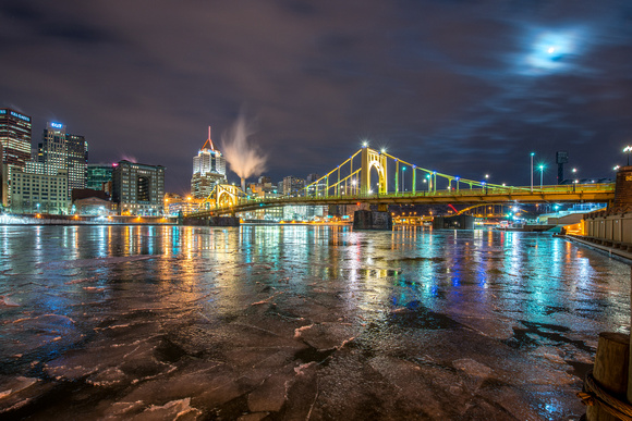 The moon reflects in the fractured ice of the Allegheny River in Pittsburgh