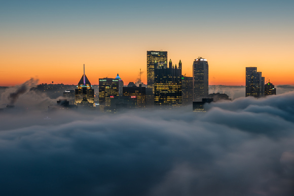 Pittsburgh glows above the fog before sunrise